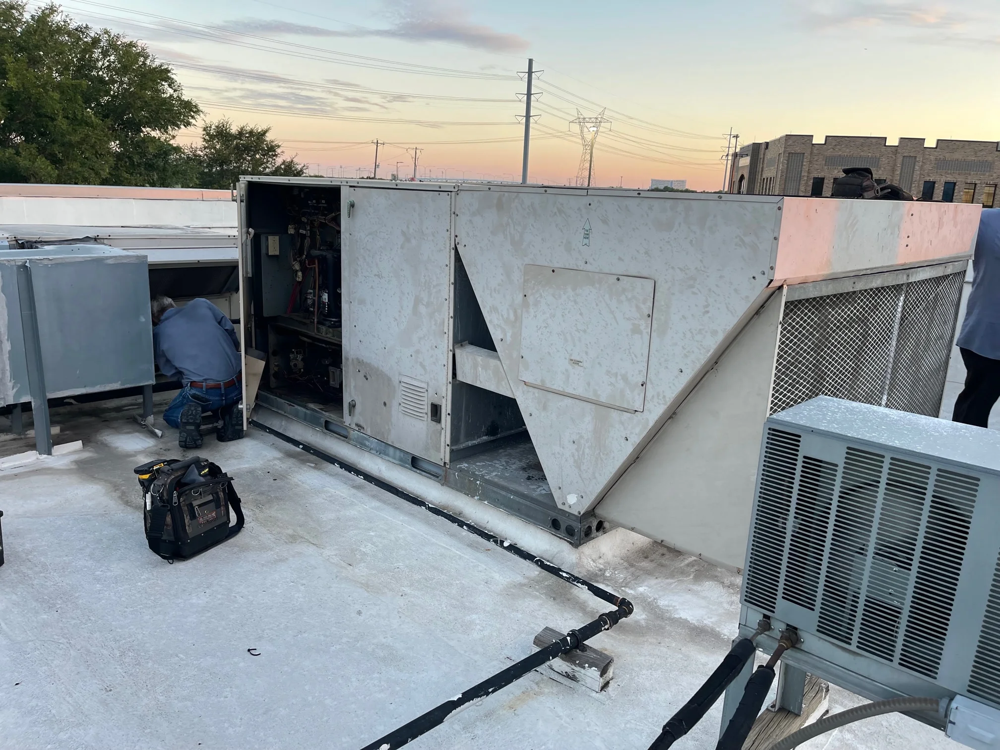 Our Service Manager removing the gas line connection in preparation for the replacement of this Lennox commercial rooftop gas package unit in Frisco, Texas