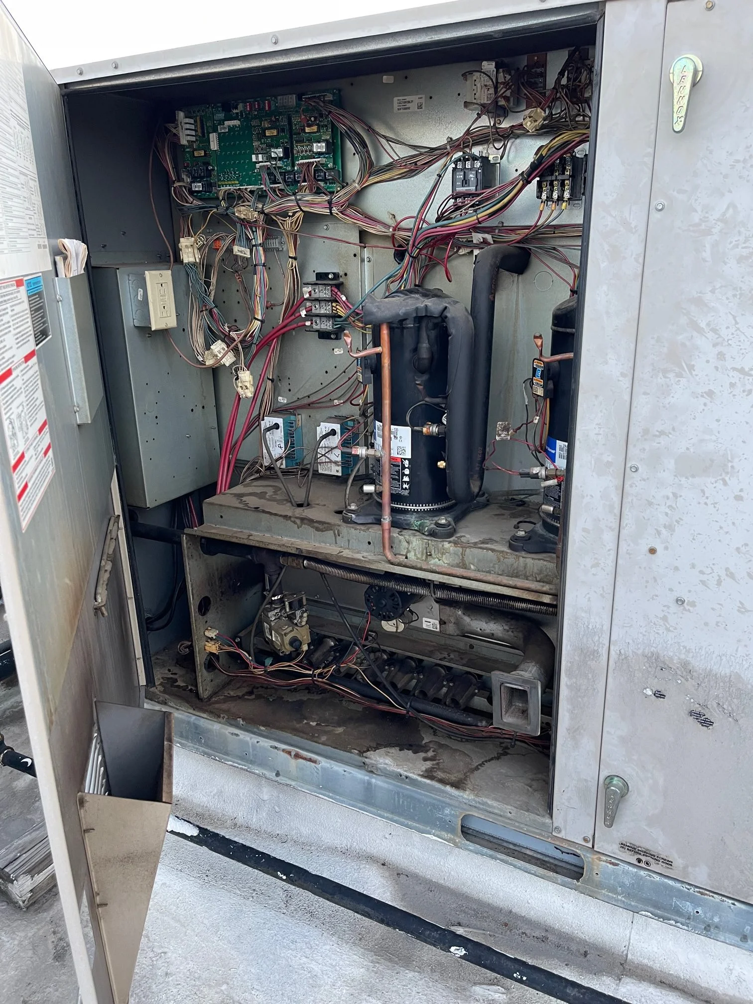 A look inside the service panel of a Lennox commercial rooftop gas package unit 